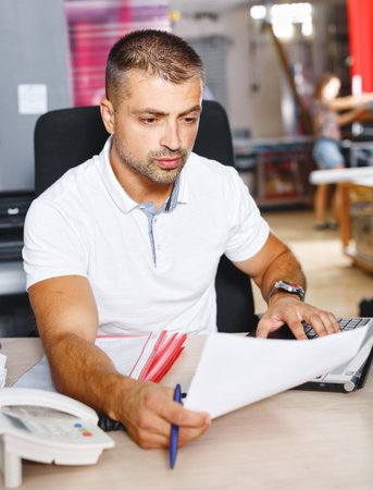 portrait of a working man at a printer studio