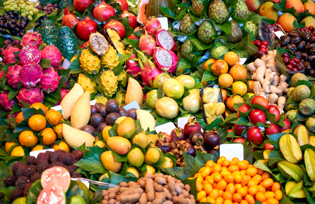 Fresh fruits in the market. Exotic fresh fruits on a market.Strawberry, blueberry, papaya, dragon fruit, kiwi, passion fruit.の写真素材