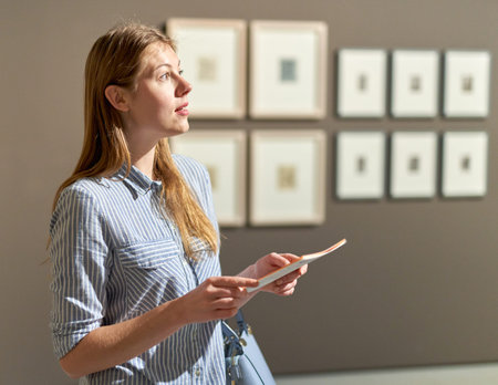 woman visitor in the historical museum looking at pictures