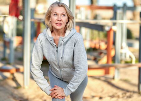 elderly attractive woman during sports by the seaの写真素材