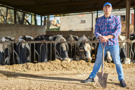 portrait of a man on livestock ranches with a shovel