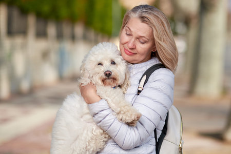 woman walking with dog in summer city.