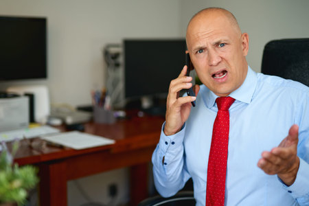 serious business man, lawyer, attorney talking on the phone has a problem