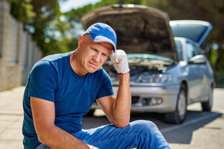 Upset driver man in front of automobile broken car collision accident in city road.