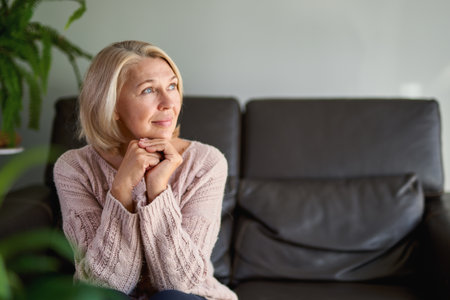 Close up Portrait Senior Woman Sitting on Sofaの写真素材