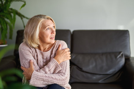 Close up Portrait Senior Woman Sitting on Sofaの写真素材