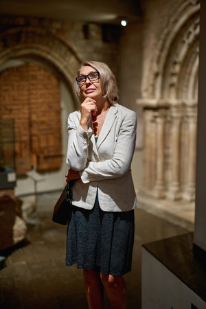 Mature woman visiting antique museumの写真素材
