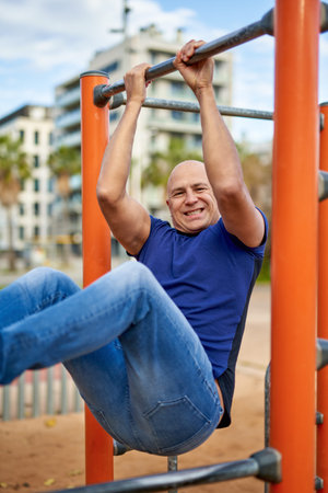 Street sports.Man is doing exercises on the bar.
