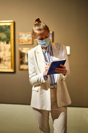 Woman visitor in the historical museum looking at picturesの写真素材
