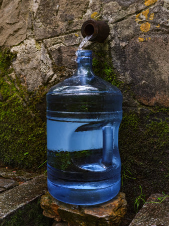 Bottle with fresh cold natural spring water from sourceの写真素材