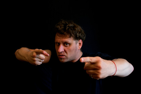 Man points his fingers at the camera. He is determined. It requires a fight.の写真素材
