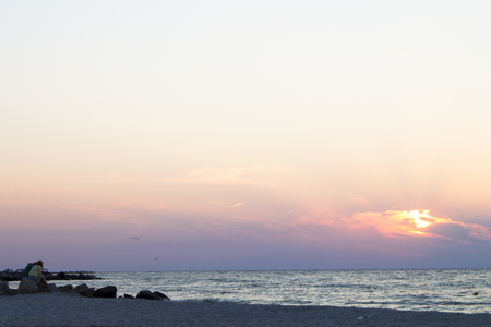 Sunrise and sunset on the sea. A man and a woman on the beach.の写真素材