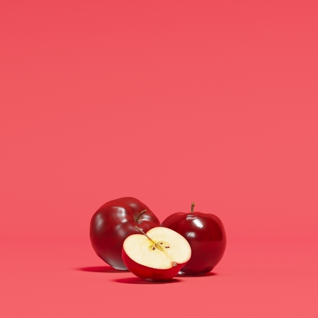 Red apples on red background for copy space. minimal concept.の写真素材