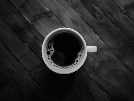 Coffee cup on black wooden table. Top view, flat layの素材