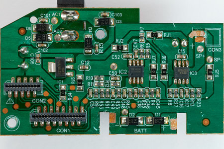 Electronic circuit board with microchips and capacitors close upの写真素材