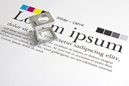 Magnifier on a test print sheet with "lorem ipsum" blind text checking Measurement and Color Managementの写真素材