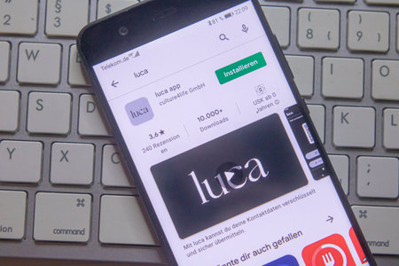 Neckargemuend, Germany: February 23, 2021: app icon of the a new german covid-app named luca on phone screen top view on keyboard, Illustrative Editorial.のeditorial素材