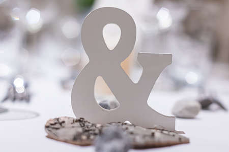three dimensional bright Ampersand sign on a white set table a wedding partyの写真素材