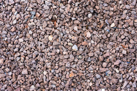 Background structure of reddish gray pebbles with sharp edges for garden and path design