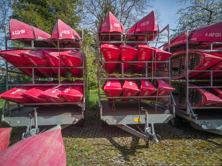 Neckargemuend, Germany: April 11, 2022: red Canoes on a car trailer in spring waiting to be used for tourist river tours in summerのeditorial素材