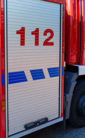 Fire Truck Roller Shutter door on a german fire engine with the european Emergency telephone number 112 printed onの写真素材