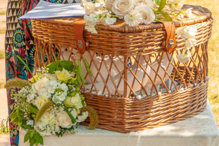woven basket with white doves waiting for their flight at a wedding celebrationの写真素材