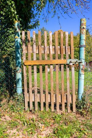 old simple wooden garden gate at the entrance to a small gardenの写真素材