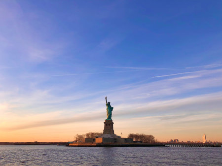 NEW YORK - JANUARY 4, 2022: Miss Liberty even outshines the Sun at sunsetのeditorial素材