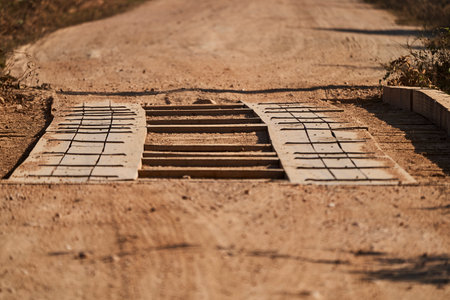 small and robust wooden bridge along the red dirt road of the Transpantaneira through the wetlands of the Pantanal swamp towards Porto Jofre at Cuiaba river, Brazil, South Americaの写真素材