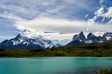 Cuernos, Horns of torres del paine covered with snow at torres del paine national park in the Andes of southern Chile in south America, towering over the turquoise water of lake Pehoe with dramatic clouds in the sky_2の写真素材
