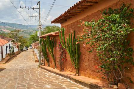 small historic alleyway with sandstone cobble stone in the historic colonial town of Barichara in Colombia, a popular tourist travel destination in andes mountains, south americaの写真素材
