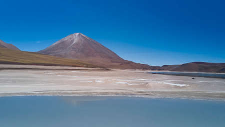 Aerial with stunning view of laguna verde at the foot of licancabur volcano, in the altiplano of Bolivia at high altitude of the andes mountains, South Americaの写真素材