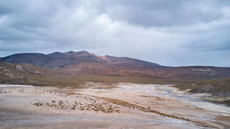 aerial of a vast and desolate landscape of a hot spring in high altitude in the highlands of the Andes in Chile, south americaの写真素材
