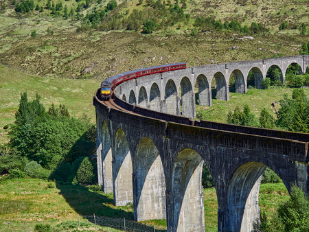 Glenfinnan, Scotland - 05 29 2018: iconic jacobite steam train crossing the Glenfinnan viaduct in the scottish highlands famous from the Harry Potter movieのeditorial素材