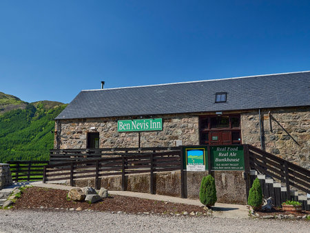 Achintee, Scotland - 05 30 2018: old stone cottage of the Ben Nevis Inn in the highlands of Scotland on a sunny day with clear blue sky.のeditorial素材