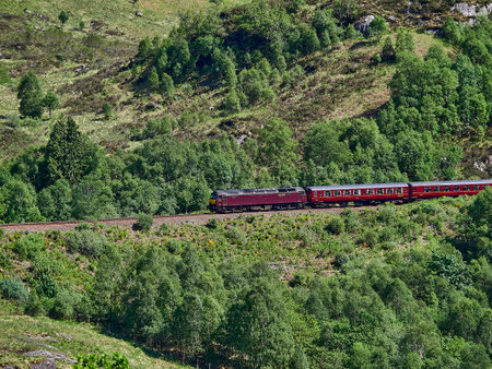 Glenfinnan, Scotland - 05 29 2018: iconic jacobite steam train crossing the Glenfinnan viaduct in the scottish highlands.のeditorial素材