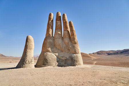 Antofagasta, Chile - 02 16 2019: Mano del desierto, a giant sculpture of a hand with fingertips reaching to the sky. located at the panamericana close to antofagasta in the atacama desert, chile.のeditorial素材