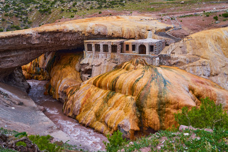 Puente del Inca, Argentina - 01 13 2019: Puente del Inca, the Inca Bridge, is a natural arch that forms a bridge over the Las Cuevas River in Argentina, South America, with a natural sulfuric spring, used as a spa in an old buildingのeditorial素材