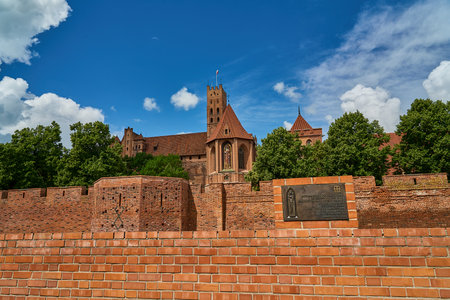 Malbork, Poland - 06 27 2023: The Castle of the Teutonic Order in Malbork along the Nogat river in Poland is the biggest brick building in the world.の写真素材
