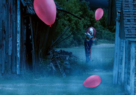 a scary clown in an eerie setting waves the viewer to himの写真素材