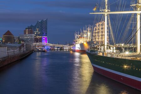 Hamburg germany the elbphilharmony hamburg with ships in the foreground during blue hourのeditorial素材