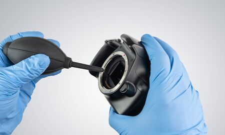 a professional cleaning of a camera body with a bellow and glovesの写真素材