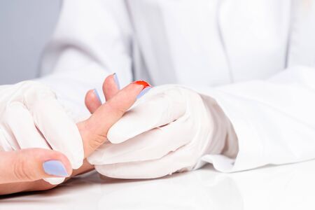 a doctor examines a cut wound on a handの写真素材