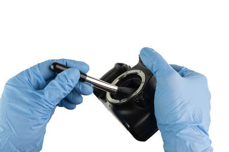 professional cleaning of a camera housing with a bellows and hand glovesの写真素材