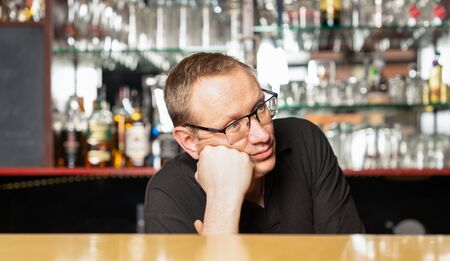 a pub host worries because of no guests in his pubの写真素材