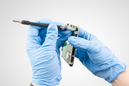 a professional repairs a hard drive under laboratory conditionsの写真素材