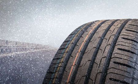 A tire in close-up on a snowy roadの写真素材