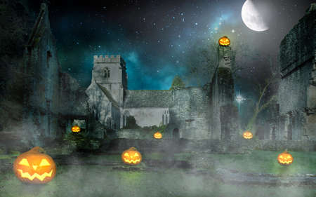 scary halloween pumpkin lanterns in front of an old building at nightの写真素材