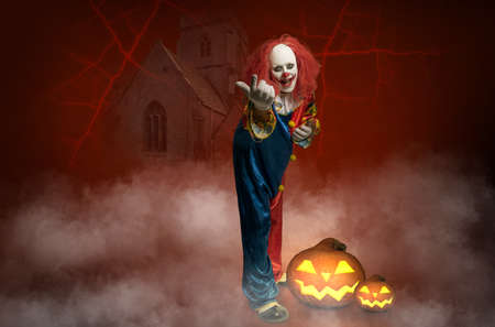 a creepy clown in front of an abstract background attracts the viewerの写真素材