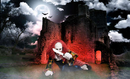 an evil clown in front of an old castle ruinの写真素材